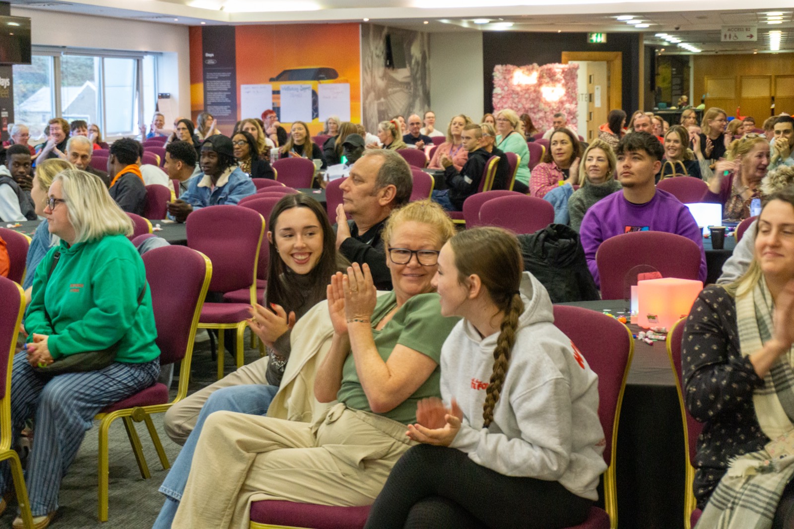 Audience clapping at a VFCC event